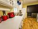 Close-up view of a kitchen sink, countertop, and appliances with white cabinets and wood floors at 422 Academy Rd, Walterboro, SC 29488