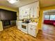 An open kitchen features stainless steel washer/dryer, white appliances and cabinetry at 422 Academy Rd, Walterboro, SC 29488