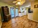 Bright kitchen with wooden floors, white appliances, cabinetry, ceiling fan and exterior access at 422 Academy Rd, Walterboro, SC 29488