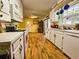 Bright kitchen with wood flooring, modern appliances, white cabinetry, and natural light at 422 Academy Rd, Walterboro, SC 29488