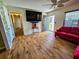 Modern living room with beautiful wood-look floors, statement wallpaper, and contemporary decor at 422 Academy Rd, Walterboro, SC 29488