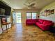 Spacious living room featuring wood-look flooring and a comfortable red sectional at 422 Academy Rd, Walterboro, SC 29488