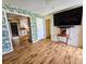 Open-concept living room featuring wood-look floors, stylish wallpaper, and seamless flow to the kitchen at 422 Academy Rd, Walterboro, SC 29488