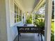 Inviting front porch with white columns and a comfortable bench seating area at 422 Academy Rd, Walterboro, SC 29488