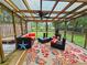 Outdoor seating area in the screened porch at 422 Academy Rd, Walterboro, SC 29488