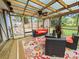 Cozy screened porch with seating, ceiling fan, and outdoor access at 422 Academy Rd, Walterboro, SC 29488