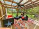 A view of the screened porch and its outdoor furniture at 422 Academy Rd, Walterboro, SC 29488