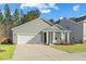 A well-maintained home with a two-car garage and a cozy front porch at 4316 Cotton Flat Rd, Summerville, SC 29485