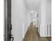 Bright hallway featuring hardwood floors and neutral walls, leading into the home's living spaces at 4316 Cotton Flat Rd, Summerville, SC 29485