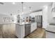 Open-concept kitchen with an island, stainless steel appliances, white cabinets and a view into the living room at 4316 Cotton Flat Rd, Summerville, SC 29485