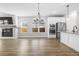 Open-concept kitchen and living room featuring stainless steel appliances, island with sink, fireplace, and tv at 4316 Cotton Flat Rd, Summerville, SC 29485