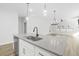 A kitchen island with a stainless steel dishwasher, sink, and a light gray countertop with pendant lighting above at 4316 Cotton Flat Rd, Summerville, SC 29485