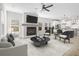 Cozy living room features a fireplace, comfortable seating, and an open view into the kitchen and dining area at 4316 Cotton Flat Rd, Summerville, SC 29485