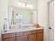 Stylish bathroom with a large mirror, a single sink vanity, and wood cabinets at 4343 Ten Shillings Way, Ravenel, SC 29470