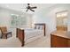 Cozy bedroom featuring a window with shutters, carpet, and a wooden bed frame with blue accents at 4343 Ten Shillings Way, Ravenel, SC 29470