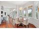 Bright breakfast nook featuring a round table, hardwood floors, and large windows at 4343 Ten Shillings Way, Ravenel, SC 29470