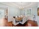 Elegant dining room with wainscoting, hardwood floors, a chandelier, and natural light at 4343 Ten Shillings Way, Ravenel, SC 29470
