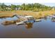 Tranquil view of a wooden dock with a covered seating area on the waterway at 4343 Ten Shillings Way, Ravenel, SC 29470