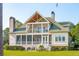 Stately two-story home boasting a screened porch, second floor balcony and elegant architectural details at 4343 Ten Shillings Way, Ravenel, SC 29470