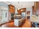 Gourmet kitchen features a central island, stainless steel appliances, and custom wood cabinets at 4343 Ten Shillings Way, Ravenel, SC 29470