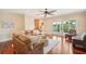 Spacious living room with hardwood floors, comfortable seating, and a sliding glass door to the outside at 4343 Ten Shillings Way, Ravenel, SC 29470