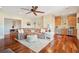 Open living room with hardwood floors, wet bar, large sectional couch and custom ceiling fan at 4343 Ten Shillings Way, Ravenel, SC 29470