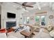Inviting living room with a fireplace, hardwood floors, and natural light from French doors at 4343 Ten Shillings Way, Ravenel, SC 29470