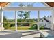 Scenic outdoor view from a covered porch, showcasing lush greenery and a charming white house at 4343 Ten Shillings Way, Ravenel, SC 29470