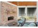 Inviting screened porch with a fireplace, ceiling fan, and views of the backyard at 4343 Ten Shillings Way, Ravenel, SC 29470