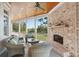 Relaxing screened porch with a brick fireplace, ceiling fan, and views of the backyard at 4343 Ten Shillings Way, Ravenel, SC 29470