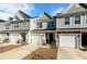 Attractive townhome row boasting varied siding, garages, and fresh landscaping at 447 Duskywing Dr, Goose Creek, SC 29445