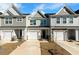Charming townhomes featuring varied siding, attached garages, and manicured lawns under a sunny sky at 447 Duskywing Dr, Goose Creek, SC 29445