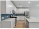 Bright kitchen featuring white cabinets, stainless steel appliances, and a blue backsplash at 447 Duskywing Dr, Goose Creek, SC 29445