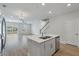 View from the kitchen into the living area featuring a large island and stainless steel appliances at 447 Duskywing Dr, Goose Creek, SC 29445