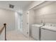 Hallway laundry room with included appliances and wire shelving for storage at 447 Duskywing Dr, Goose Creek, SC 29445