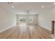 Bright living room with hardwood floors, a ceiling fan, and sliding glass door access to the backyard at 447 Duskywing Dr, Goose Creek, SC 29445