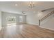 Open living area with a ceiling fan, hardwood floors, a chandelier, and a sliding glass door at 447 Duskywing Dr, Goose Creek, SC 29445