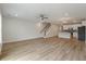 Spacious living room with wood floors open to modern kitchen and staircase with wood banister at 447 Duskywing Dr, Goose Creek, SC 29445