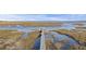 Scenic aerial view of a wooden walkway leading to the water with a blue sky background at 4877 Sound View Dr, Mount Pleasant, SC 29466