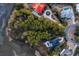 Aerial view of homes with lush landscaping, private pools, and colorful roofs in a coastal setting at 4877 Sound View Dr, Mount Pleasant, SC 29466