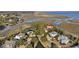 Aerial view of waterfront homes in marsh setting with private drives and mature trees at 4877 Sound View Dr, Mount Pleasant, SC 29466