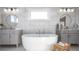 Modern bathroom with a freestanding tub, dual vanities, and elegant tile work at 4877 Sound View Dr, Mount Pleasant, SC 29466