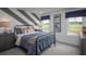 A modern bedroom is decorated with athletic themed art and features a black metal bed frame at 4877 Sound View Dr, Mount Pleasant, SC 29466