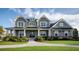 Charming two-story home with gray siding, manicured lawn, and covered porch at 4877 Sound View Dr, Mount Pleasant, SC 29466
