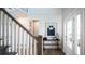 Bright foyer boasts paneled wall accents, hardwood flooring, and stairway with painted white wood spindles at 4877 Sound View Dr, Mount Pleasant, SC 29466