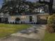 Inviting single-story home featuring a covered carport, landscaping, and freshly painted exterior at 5107 Temple St, North Charleston, SC 29405