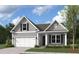 Cozy one-story home featuring gray siding, a front-entry garage, and charming curb appeal at 512 Eagleview Dr, Moncks Corner, SC 29461