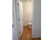 Powder room with hardwood floors, toilet, and white walls, providing a clean and functional space at 5208 Fernland Way, North Charleston, SC 29420