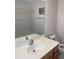 Bathroom with a large mirror, white sink, and toilet next to a shower/tub combo at 5208 Fernland Way, North Charleston, SC 29420