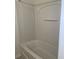Bright white bathtub and shower combination with built in shelving at 5208 Fernland Way, North Charleston, SC 29420